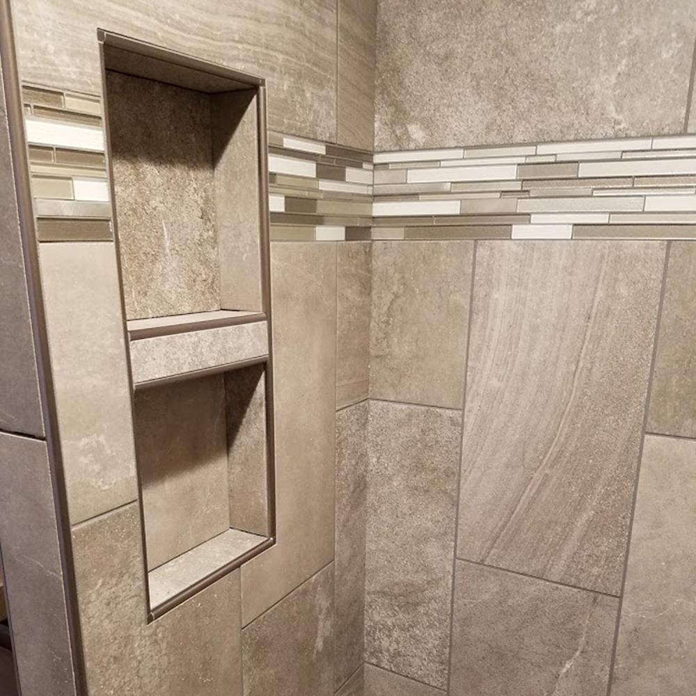 Shower niche wrapped in Schluter metal with glass accent tile Shower niche wrapped in Schluter metal with glass accent tile