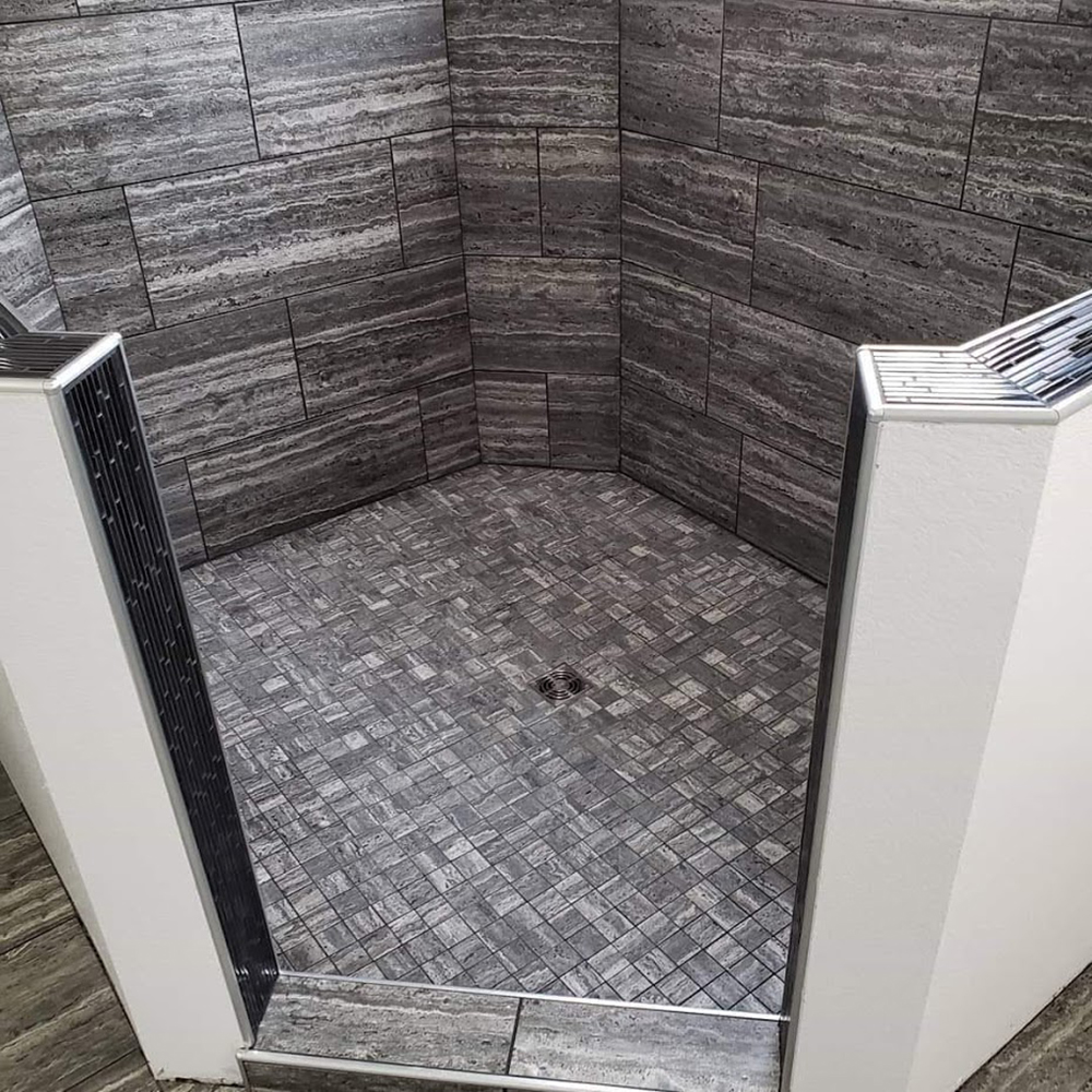 Black glass deco accent tile wrapped in Schluter metal Black glass deco accent tile wrapped in Schluter metal